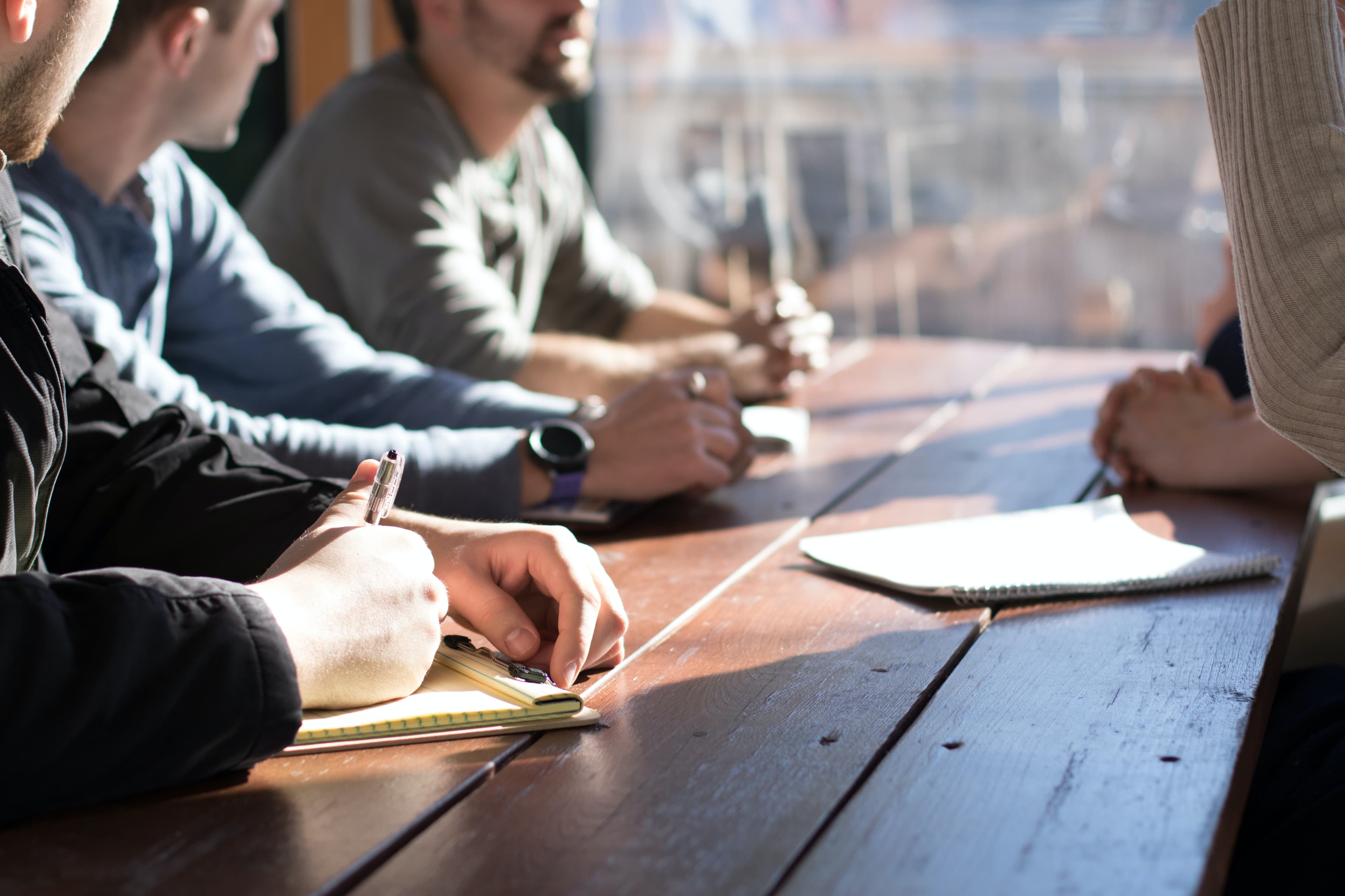 Several people talking around a table